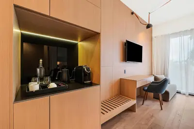 a room with a kitchen with a sink and a desk at The March Hotel in Miami Beach