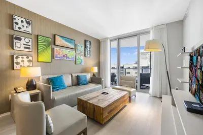 a living room with a couch and a table at Beautiful Views From a Comfortable Condo with Beach Access! in Hollywood