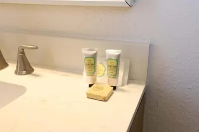 a bathroom counter with two cups and a box on it at South of Fifth Studio Steps to Beach on Ocean Drive in Miami Beach