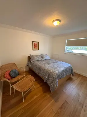 a bedroom with a bed and a chair at Key Biscayne Beach Vacation in Miami
