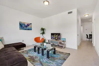 a living room with a couch and a table at Magical 2 BR Apartment 5 mins to Brickell Best Area in Miami in Miami