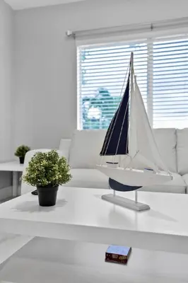 a toy sailboat on a coffee table in a living room at Celeste House Enjoy Caribbean 2 BR APT in Miami