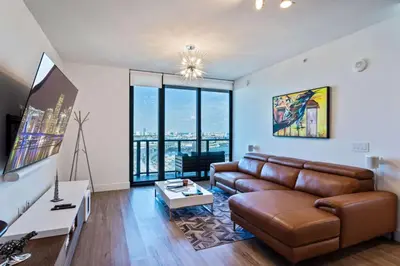 a living room with a couch and a table at Lux 2BD Apt with Stunning Water Views in Miami