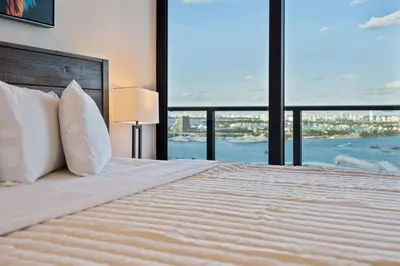 a bedroom with a large bed with a large window at Lux 2BD Apt with Stunning Water Views in Miami
