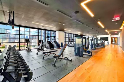 a gym with a lot of treadmills and chairs at Luxury Condo on 44th Floor - Downtown Plus Parking in Miami