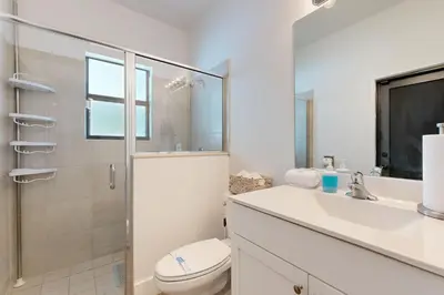 a bathroom with a toilet and a sink and a shower at Outdoor Oasis! Group-Friendly Miami Getaway in Burrs Strip