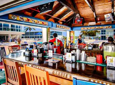 a bar in a restaurant with people in the background at Castle 1133 Ocean view studio, Pool and Beach Access, FREE Parking, Tennis and more! in Miami Beach