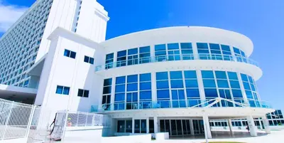 a large white building with blue windows at Castle 1133 Ocean view studio, Pool and Beach Access, FREE Parking, Tennis and more! in Miami Beach
