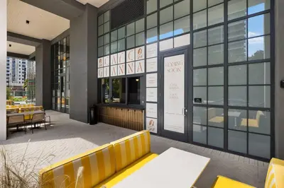a restaurant with a yellow bench in front of a building at PH 5107 Gale Luxury 1BR with Sea - Downtown Views in Miami