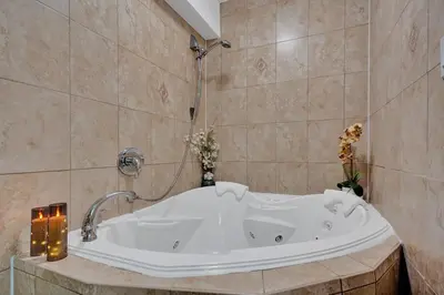 a large bath tub in a bathroom with tiles at Ocean View Serenity Condo Beach Service 915 in Miami Beach