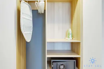 a closet with a white fan and a microwave at Stylish 2BR with Pool & Balcony in Miami