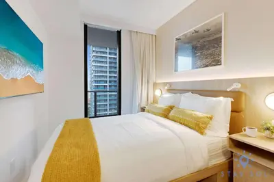 a bedroom with a large bed and a window at Stylish 2BR with Pool & Balcony in Miami