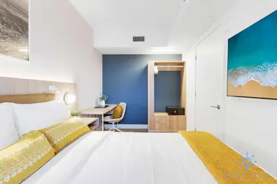 a bedroom with a large white bed and a table at Stylish 2BR with Pool & Balcony in Miami