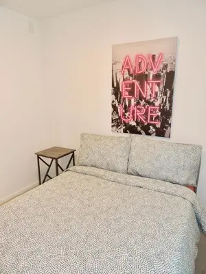 a bedroom with a bed and a painting on the wall at 2BR in Heart of SoBe with Parking in Miami Beach