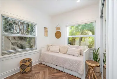 a white bedroom with a bed and two windows at Villa Treasure on the beach by The Gold Nests in Hollywood