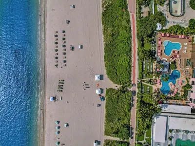 an overhead view of a beach next to the water at Charming Ocean View Condo Beach Service 806 in Miami Beach