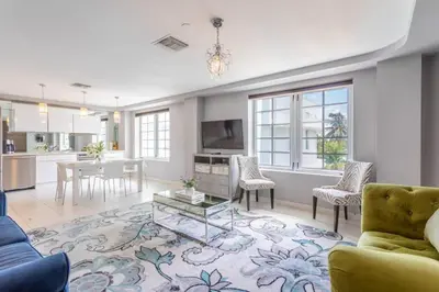 a living room with a couch and a table at Luxury Large 1BR at The Carlyle SoBe Sleeps 4 in Miami Beach