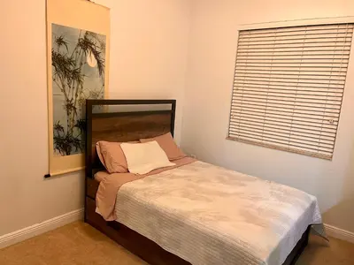 a small bed in a room with a window at Fort Lauderdale Oasis private rooms in shared house in Fort Lauderdale