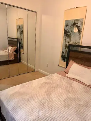 a bedroom with a large white bed and a mirror at Fort Lauderdale Oasis private rooms in shared house in Fort Lauderdale