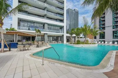 a large swimming pool in front of a building at NEW Luxury Bay View Downtown 1 Bedroom in Miami