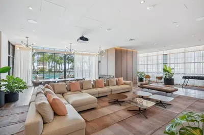 a large living room with a large couch and tables at NEW Luxury Bay View Downtown 1 Bedroom in Miami