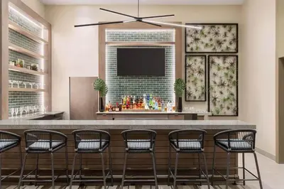 a bar with chairs and a flat screen tv at Hollywood SkyView Penthouse in Hollywood