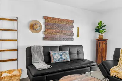 a black leather couch in a living room at Condo Stylish and Minimalist w Highlights Amenities! in Miami
