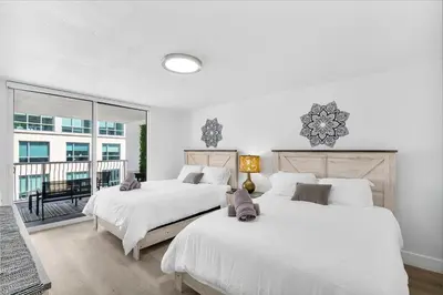 two white beds in a bedroom with a balcony at Condo Stylish and Minimalist w Highlights Amenities! in Miami
