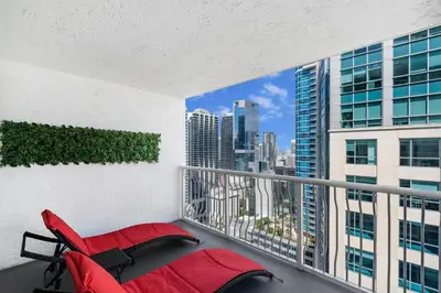 a balcony with a red bed and a view of the city at Condo Stylish and Minimalist w Highlights Amenities! in Miami
