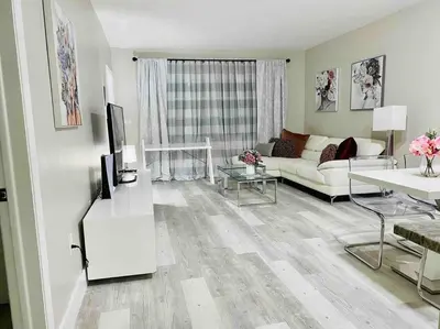 a living room with a couch and a table at Modern 1BR 1BA Condo 1Block to Aventura Mall in Aventura