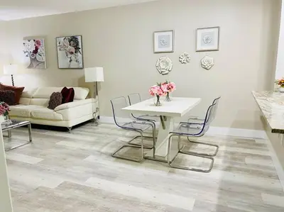 a living room with a white table and chairs at Modern 1BR 1BA Condo 1Block to Aventura Mall in Aventura