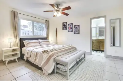 a bedroom with a large bed and a ceiling fan at Oasis of Sunrise in Sunrise