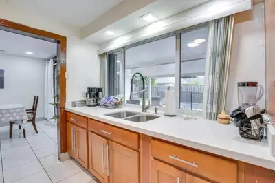 a kitchen with a sink and a large window at Oasis of Sunrise in Sunrise