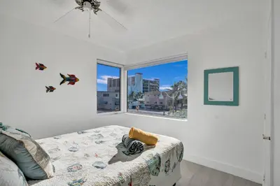 a bedroom with a bed and a large window at Sunset Oceanfront Paradise in Hollywood
