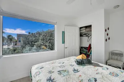 a bedroom with a bed and a large window at Sunset Oceanfront Paradise in Hollywood