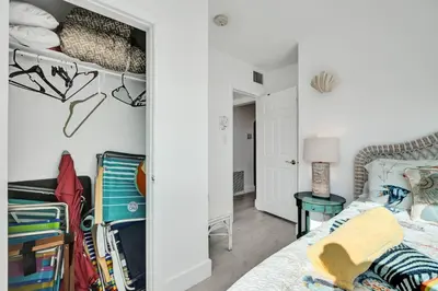 a white bedroom with a bed and a table at Sunset Oceanfront Paradise in Hollywood