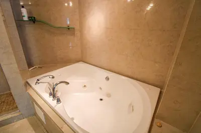 a bath tub in a bathroom with a sink at Castle L5 Oceanview Double-loft with pool, beach access, tennis, free parking! in Miami Beach
