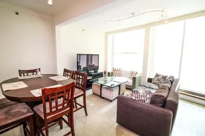 a living room with a table and a couch at Castle L5 Oceanview Double-loft with pool, beach access, tennis, free parking! in Miami Beach