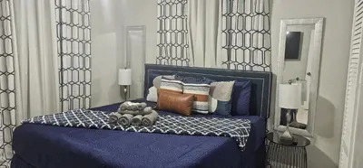 a bedroom with a blue bed with a teddy bear on it at Big TV 2 Bedroom Apartment Cooper City in Cooper City