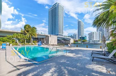 a swimming pool with a view of the city at Escape to Beachwalk Resort in Chic Apartment in Hallandale Beach