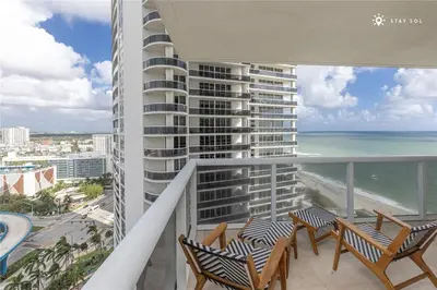 a balcony with chairs and a view of the ocean at Elegant Resort - Beautiful Views in Hallandale Beach
