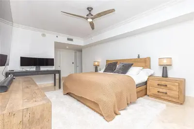 a bedroom with a large bed and a desk at Elegant Resort - Beautiful Views in Hallandale Beach