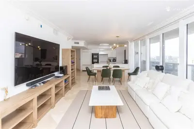 a living room with a white couch and a table at Elegant Resort - Beautiful Views in Hallandale Beach