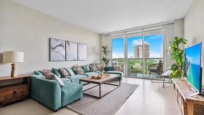 a living room with a couch and a table at Absolute Beach Bliss, Chic & Expansive Retreat in Sunny Isles Beach