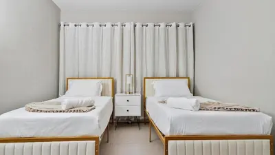 two beds sitting next to each other in a room at Absolute Beach Bliss, Chic & Expansive Retreat in Sunny Isles Beach