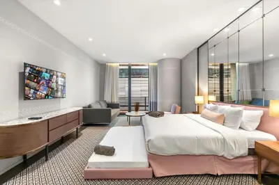 a bedroom with a large bed and a living room at Luxury King Suite W City view at SLS Brickell in Miami