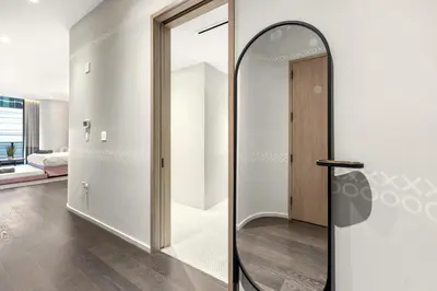 a hallway with a mirror and a room with a bed at Luxury King Suite W City view at SLS Brickell in Miami
