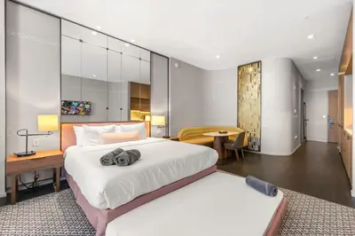 a bedroom with a large white bed and a desk at Luxury King Suite W City view at SLS Brickell in Miami