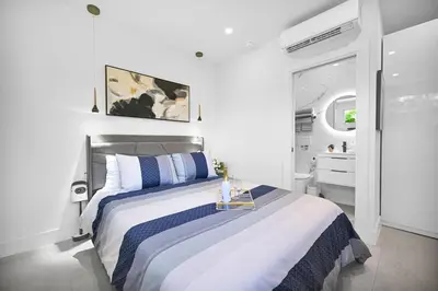 a bedroom with a bed with a table in it at Modern Studio Near Design District, Wynwood in Miami