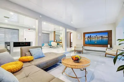 a living room with a couch and a tv at Ultimate Retreat 6BR & 3BA Villa near Beach in Dania Beach